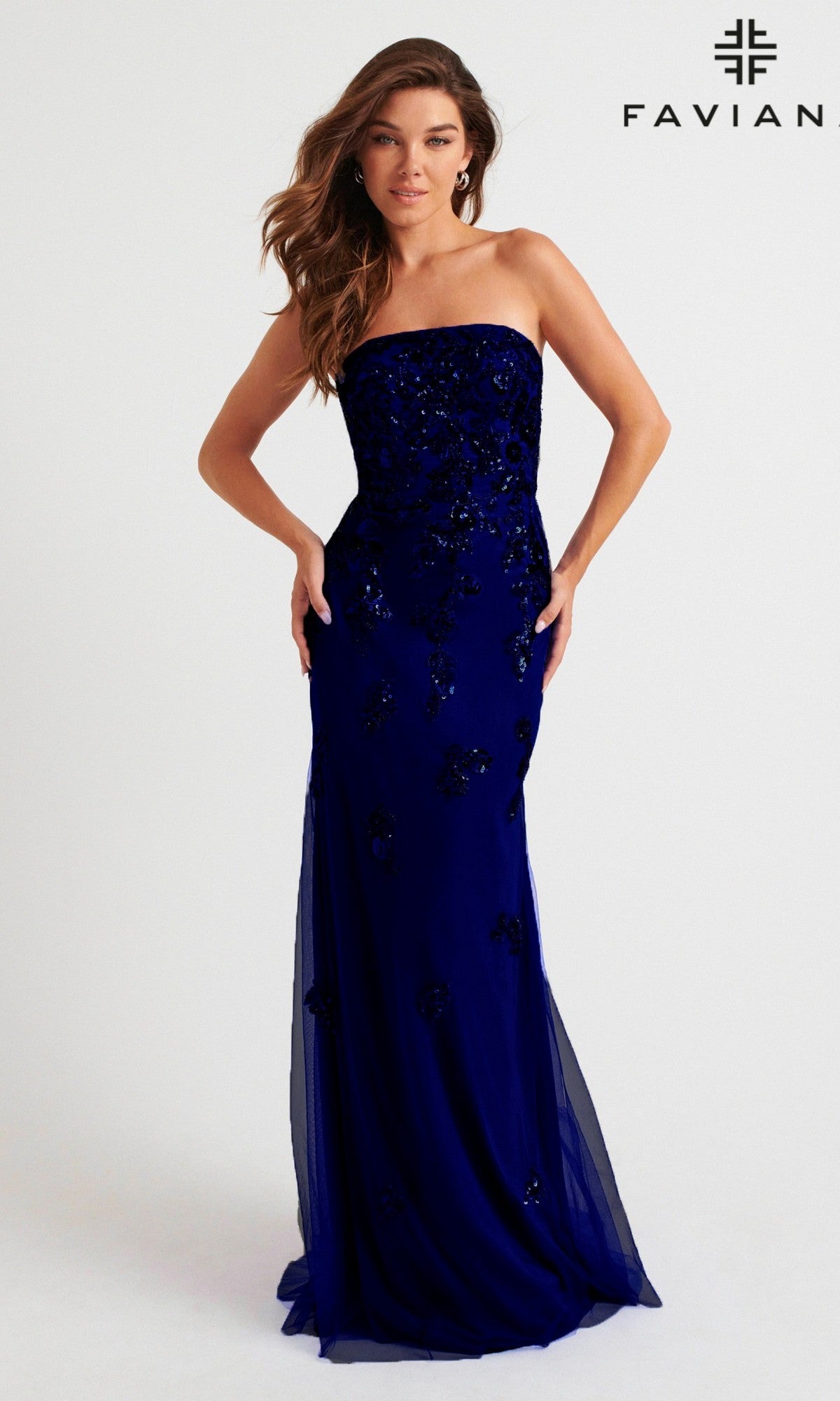 A woman wears the Faviana Strapless Long Beaded Prom Dress 11004, a floor-length dark blue gown with black sequins. The Faviana logo appears in the top right corner.